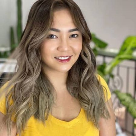 She is wearing yellow t-shirt